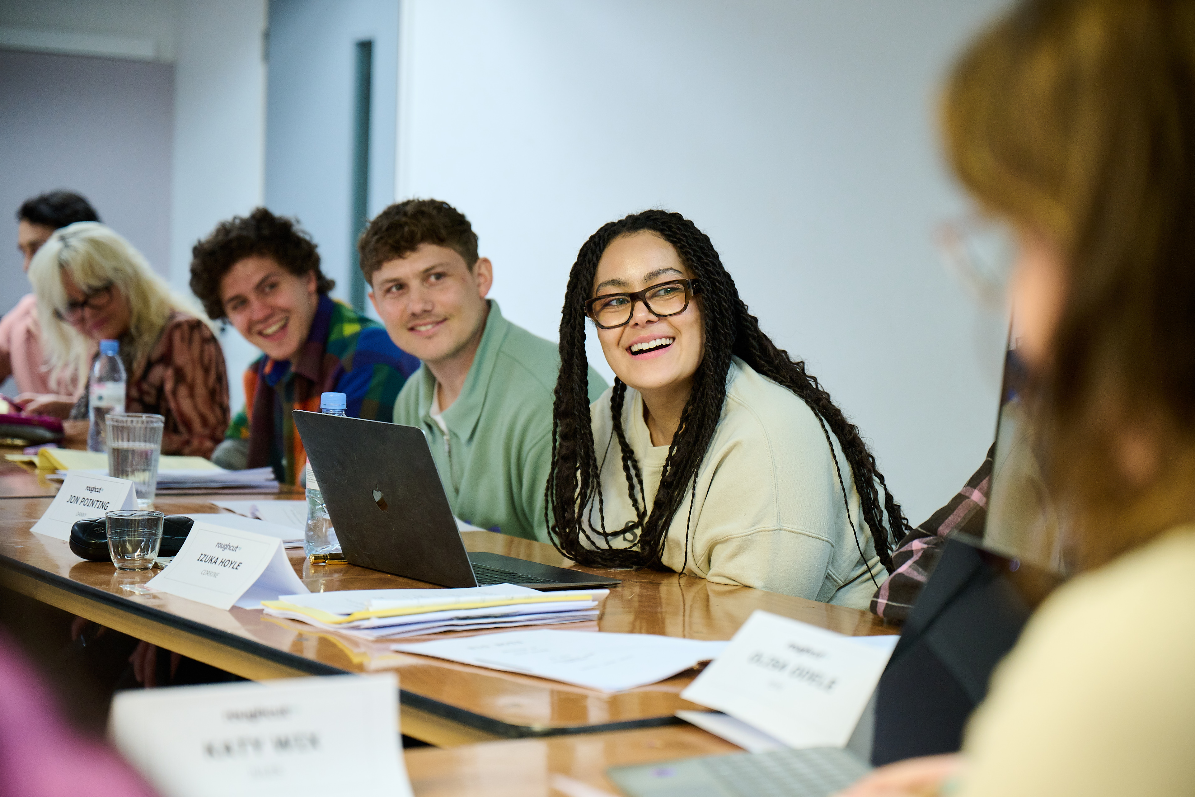 A table read featuring actors from Channel 4's series Big Boys. The actors are looking left down the table and laughing. 
