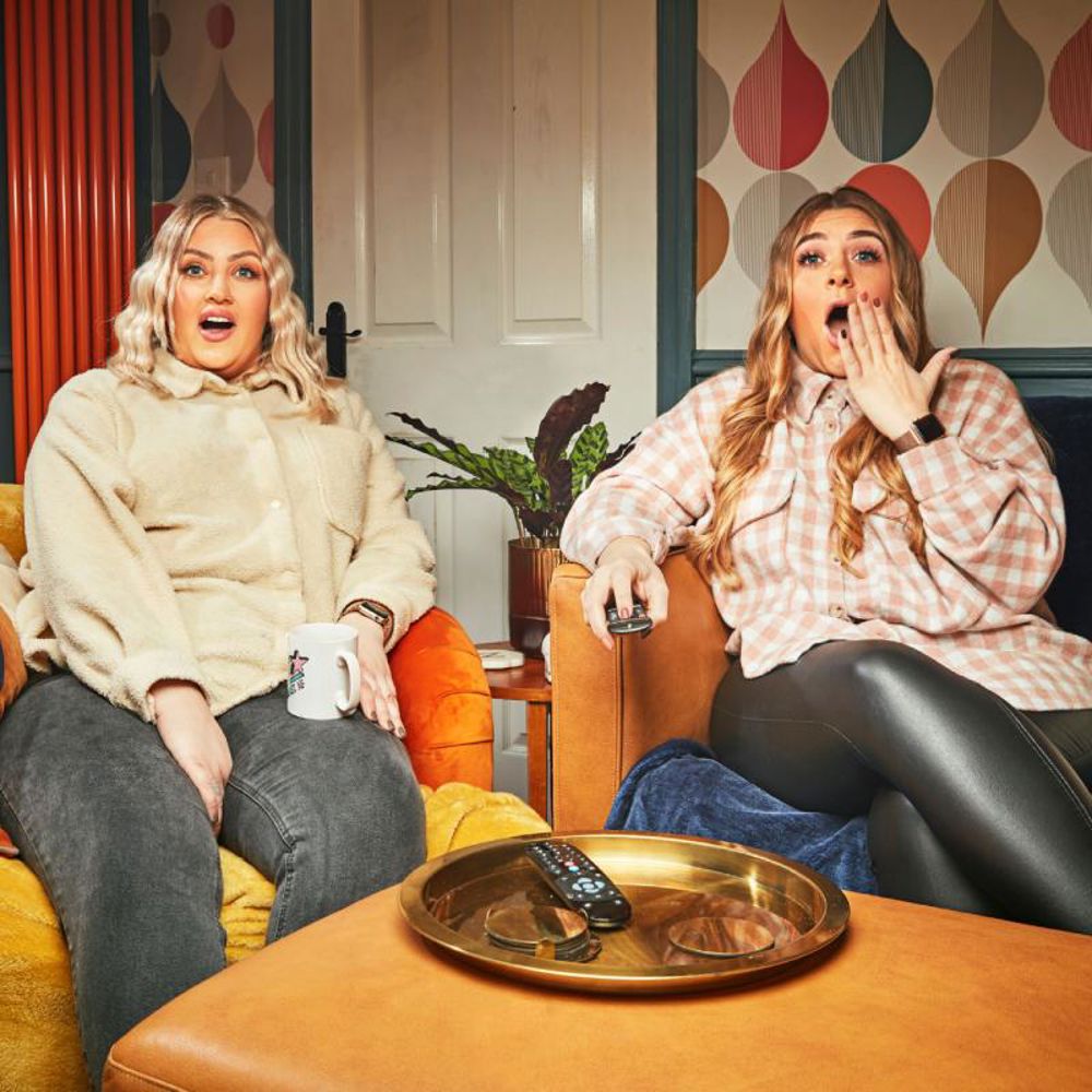 Sisters Elli and Izzi from Channel 4's Gogglebox are mouth-open, shocked at something they are watching television.